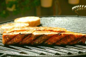 grill with 2 pieces of salmon and 2 slices of round bread