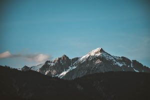 blue sky over snow capped mountains