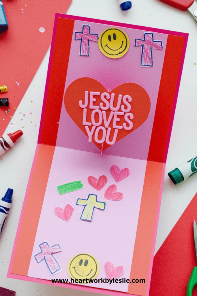 Construction paper DIY Valentine's Day Cards with a pop-up that says "Jesus Loves You."