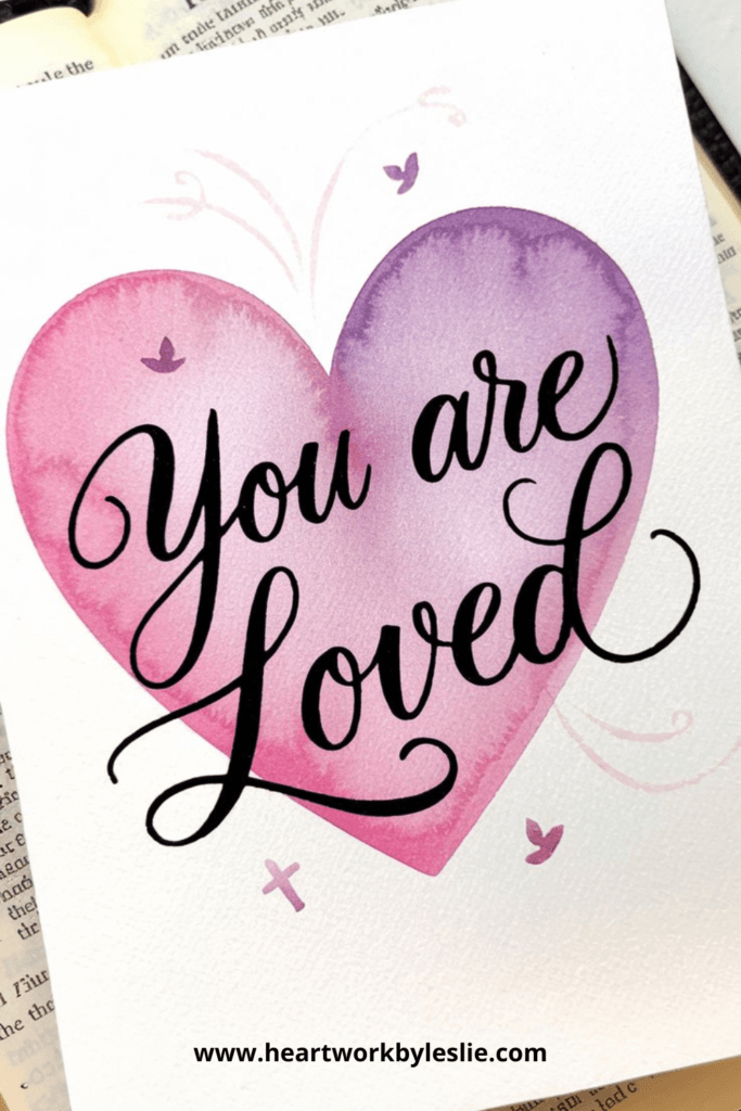 You are Loved in script on a purple watercolor heart on DIY Valentine's Day Cards.